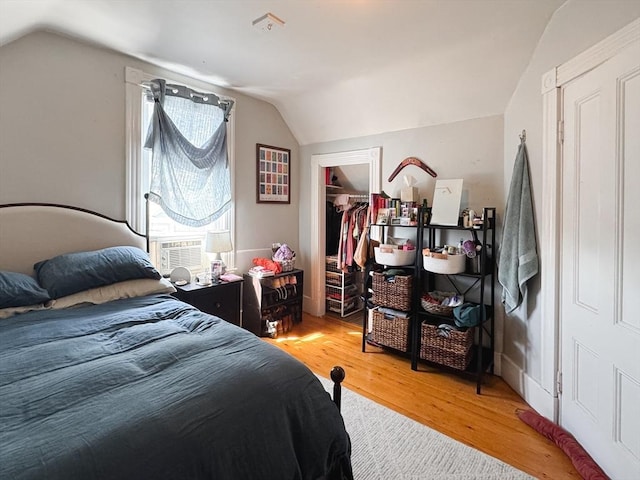 57 Bartlett St, Somerville, MA 02145 - bedroom featuring light wood-type flooring, lofted ceiling, cooling unit, a walk in closet, and a closet