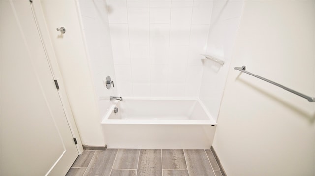 bathroom featuring bathtub / shower combination and hardwood / wood-style floors