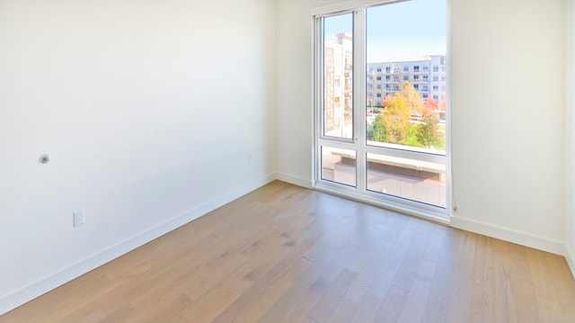 spare room featuring light hardwood / wood-style flooring