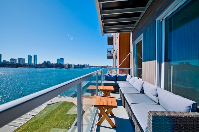 balcony featuring a water view and an outdoor hangout area