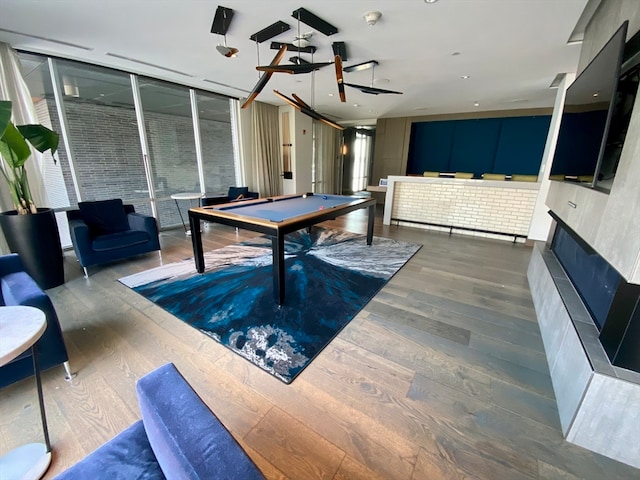 game room with hardwood / wood-style flooring and billiards