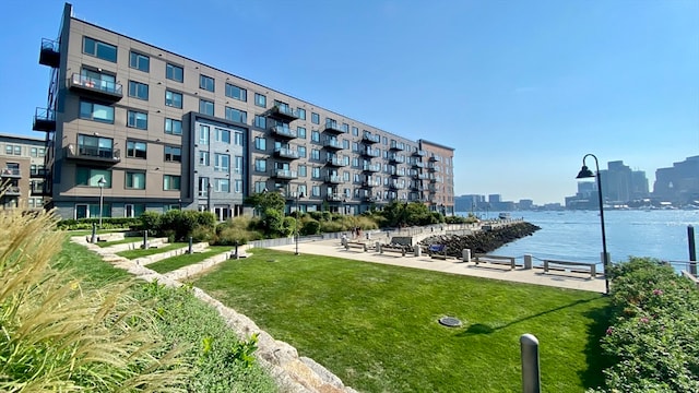 surrounding community featuring a water view and a yard