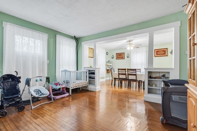 interior space with a ceiling fan and hardwood / wood-style flooring
