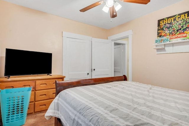 bedroom with a ceiling fan and light wood-type flooring