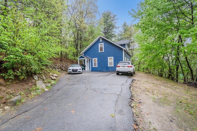 view of property exterior featuring aphalt driveway