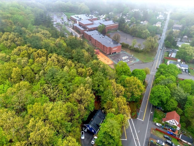 birds eye view of property with a view of trees