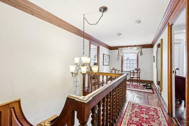 hallway featuring ornamental molding, an inviting chandelier, and dark hardwood / wood-style flooring