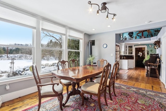 dining area featuring a wood stove and hardwood / wood-style floors