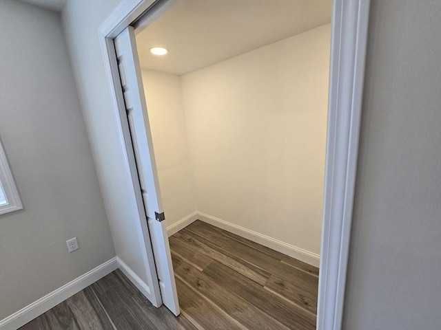 interior space with dark wood-type flooring and baseboards