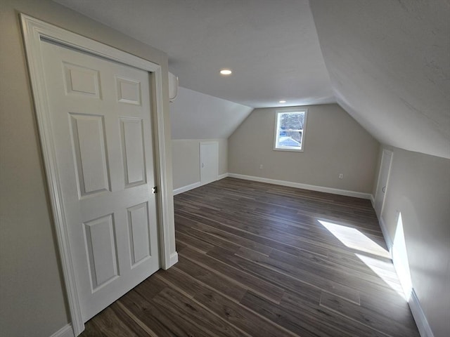 additional living space with lofted ceiling, dark wood-type flooring, recessed lighting, and baseboards