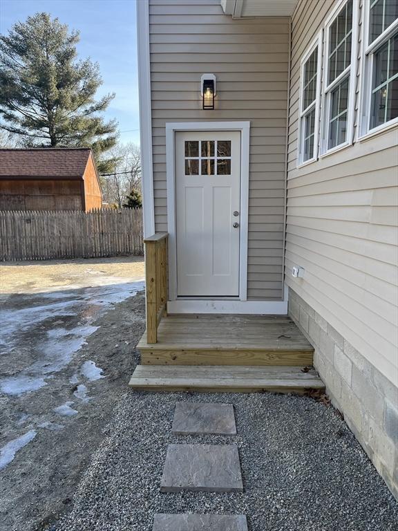 doorway to property with fence