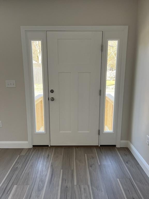 foyer entrance featuring wood finished floors and baseboards