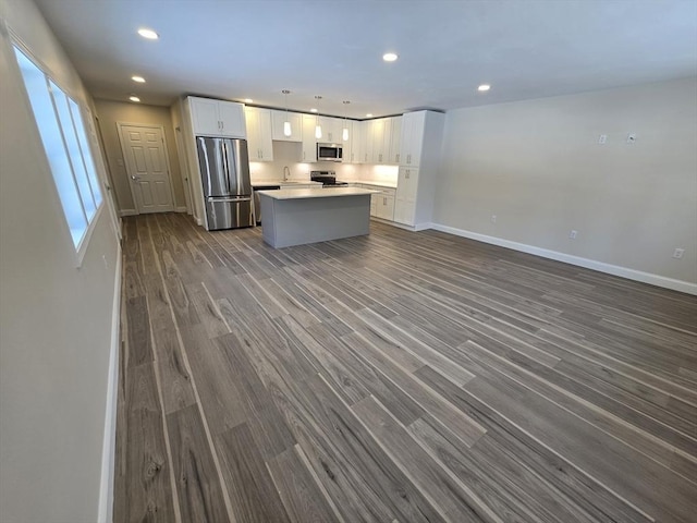 kitchen featuring a kitchen island, appliances with stainless steel finishes, white cabinets, and recessed lighting