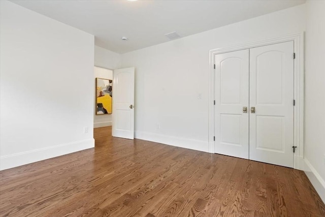 197-199 Winchester St, Brookline, MA 02446 - unfurnished bedroom featuring wood finished floors, baseboards, and a closet