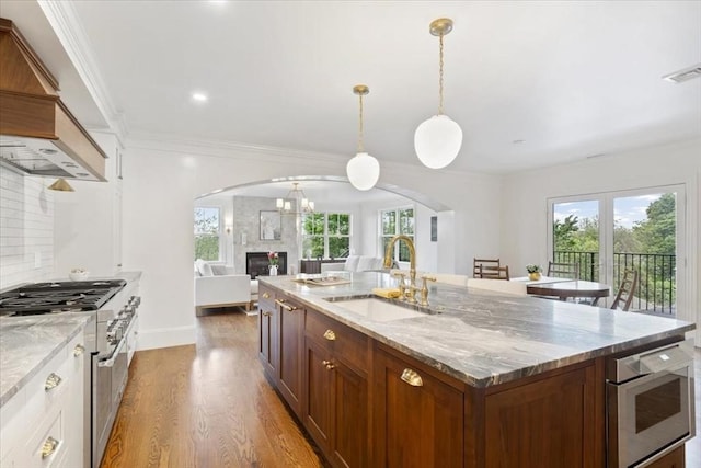 197-199 Winchester St, Brookline, MA 02446 - kitchen featuring a sink, arched walkways, appliances with stainless steel finishes, plenty of natural light, and ornamental molding