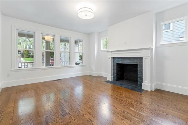 197-199 Winchester St, Brookline, MA 02446 - unfurnished living room featuring a fireplace, baseboards, and wood finished floors