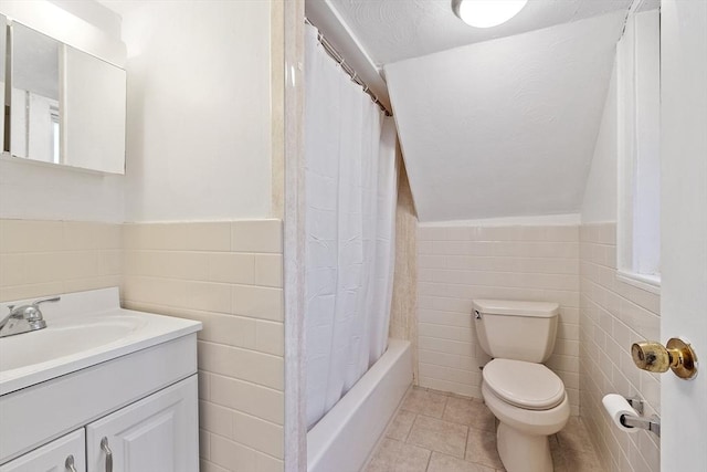 full bathroom featuring tile patterned flooring, tile walls, vanity, shower / bath combination with curtain, and toilet