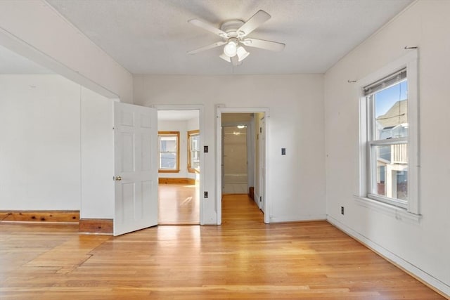 spare room featuring ceiling fan and light hardwood / wood-style flooring