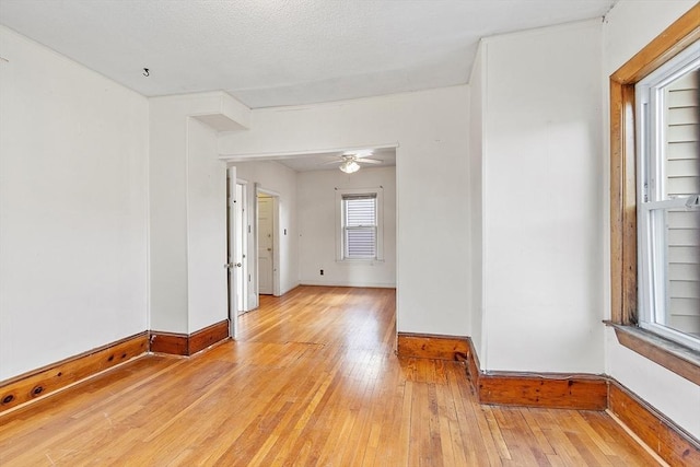 empty room featuring ceiling fan and light wood-type flooring