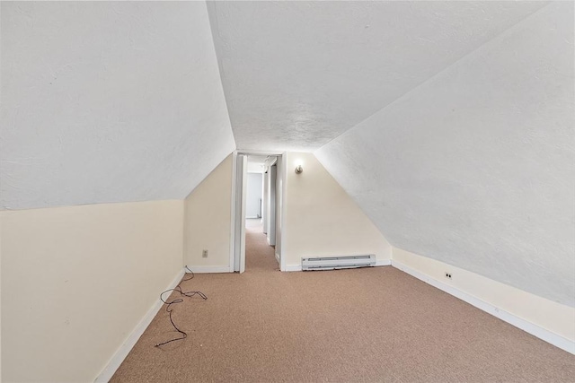 bonus room with lofted ceiling, a baseboard heating unit, light carpet, and a textured ceiling