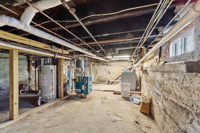 basement featuring water heater and washer / clothes dryer