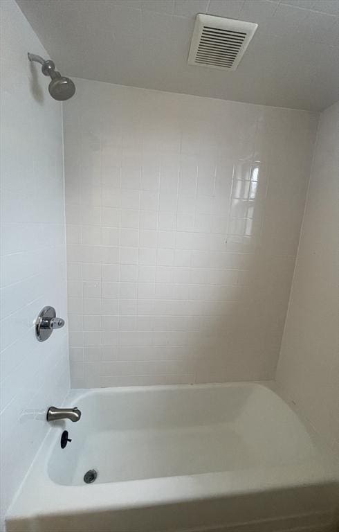bathroom with washtub / shower combination and visible vents