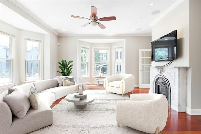 living room with dark hardwood / wood-style floors, ceiling fan, plenty of natural light, and ornamental molding