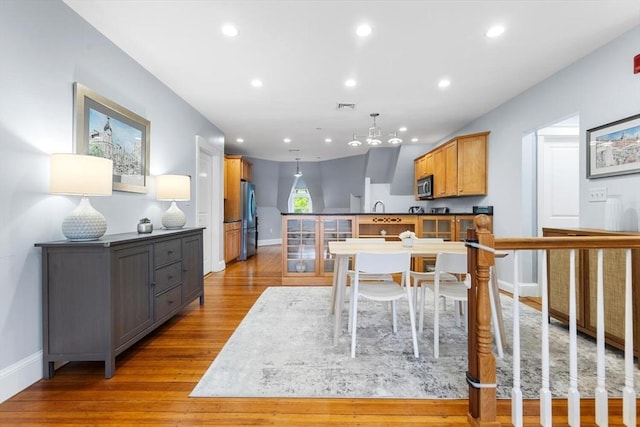 dining room with wood finished floors, baseboards, and recessed lighting