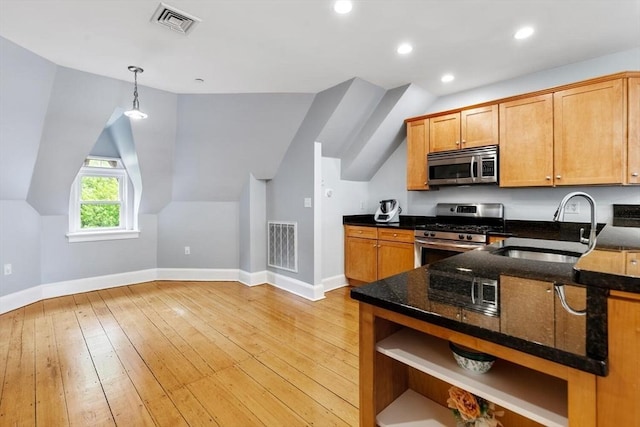 kitchen featuring stainless steel appliances, a sink, open shelves, baseboards, and light wood-style flooring