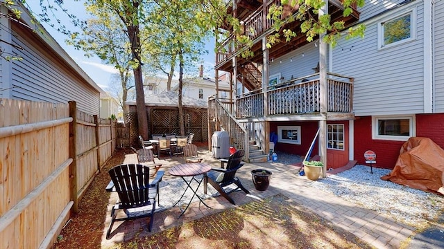 view of patio / terrace with stairs, a fenced backyard, and outdoor dining area