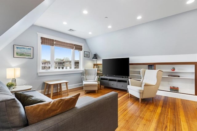 living room with wood finished floors, lofted ceiling, recessed lighting, and baseboards