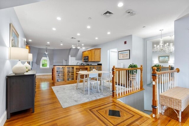 dining area featuring a chandelier, light wood-style flooring, recessed lighting, and baseboards