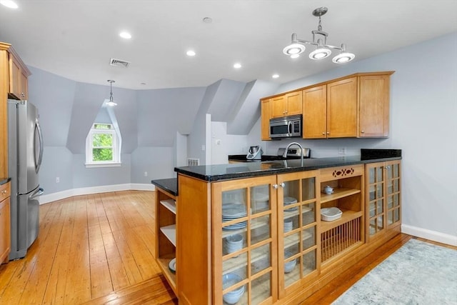 kitchen featuring stainless steel appliances, open shelves, light wood-style flooring, baseboards, and vaulted ceiling