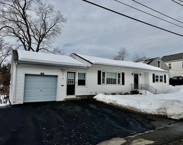 ranch-style house with aphalt driveway and an attached garage