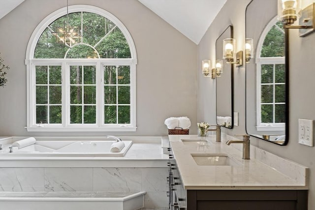 74 Charter Rd, Acton, MA 01720 - bathroom with a chandelier, double vanity, vaulted ceiling, and a bath