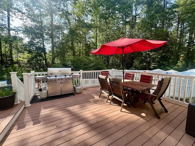 74 Charter Rd, Acton, MA 01720 - wooden terrace with outdoor dining area, grilling area, and view of scattered trees