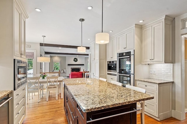 74 Charter Rd, Acton, MA 01720 - kitchen featuring stainless steel appliances, a brick fireplace, light wood-style floors, backsplash, and recessed lighting