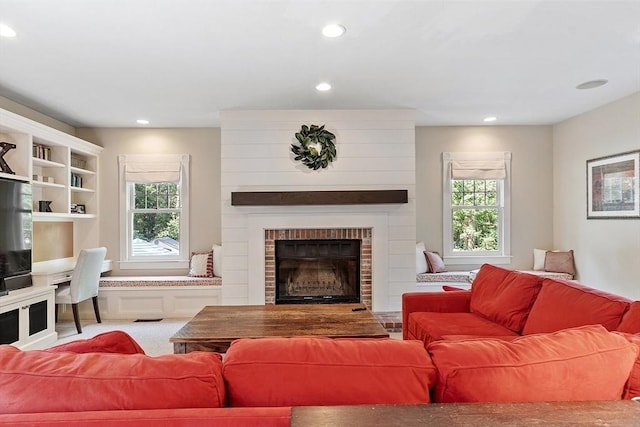 74 Charter Rd, Acton, MA 01720 - living area with plenty of natural light, recessed lighting, and a large fireplace