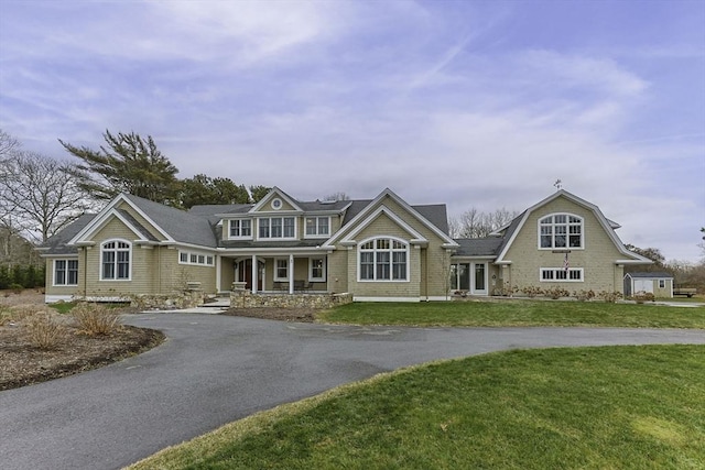 view of front of property with a front yard and covered porch