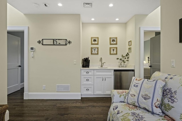 interior space featuring white cabinetry, fridge, sink, and dark hardwood / wood-style flooring