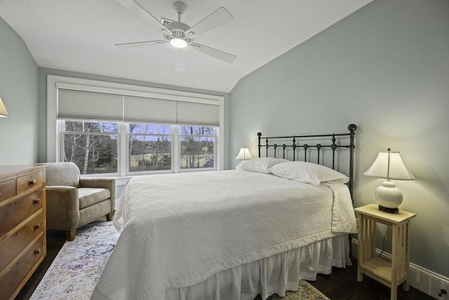 bedroom with ceiling fan, dark hardwood / wood-style flooring, and vaulted ceiling