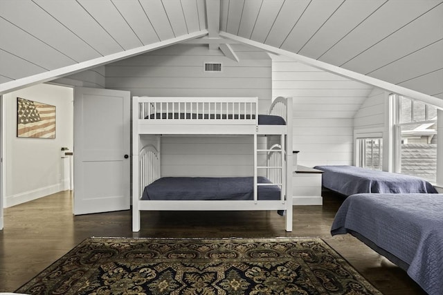 bedroom featuring dark wood-type flooring, wood walls, wood ceiling, and vaulted ceiling with beams