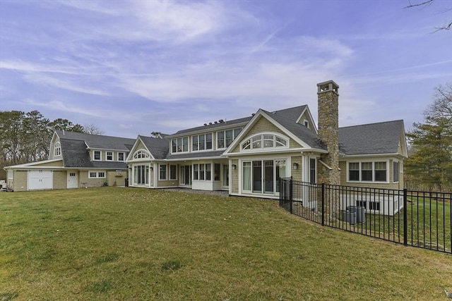 back of house featuring a yard and central AC unit