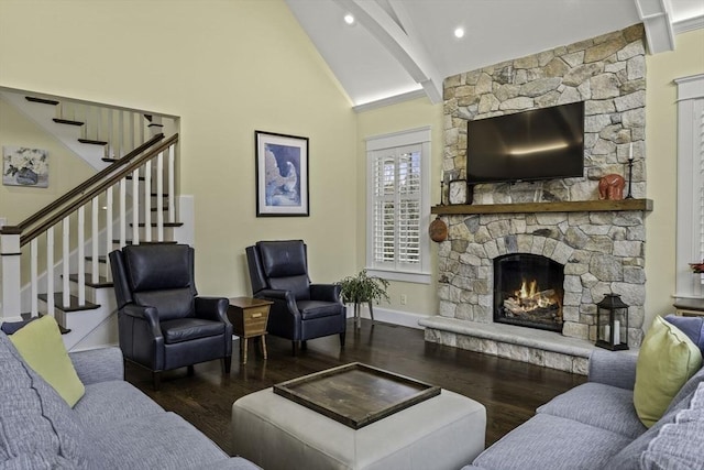 living room featuring dark wood-type flooring, a fireplace, high vaulted ceiling, and beam ceiling