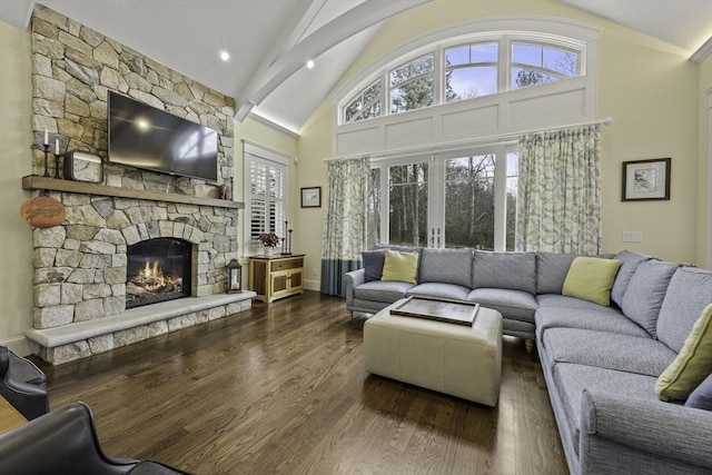 living room featuring a fireplace, plenty of natural light, dark hardwood / wood-style floors, and high vaulted ceiling