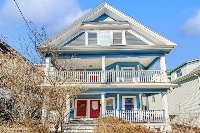 view of front of property featuring covered porch and a balcony