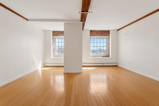 unfurnished room with light wood finished floors, baseboards, beam ceiling, and a baseboard heating unit