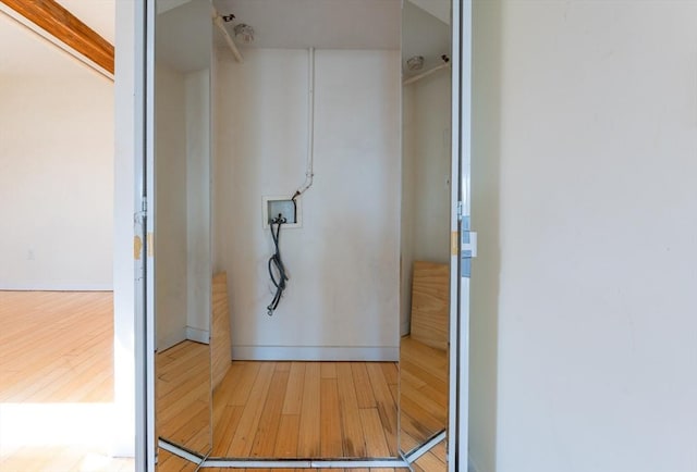 interior space with baseboards and wood finished floors