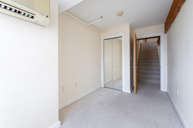unfurnished bedroom featuring baseboards, carpet flooring, and a closet