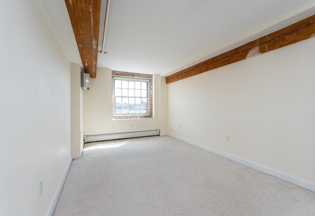 carpeted spare room with a baseboard radiator and baseboards